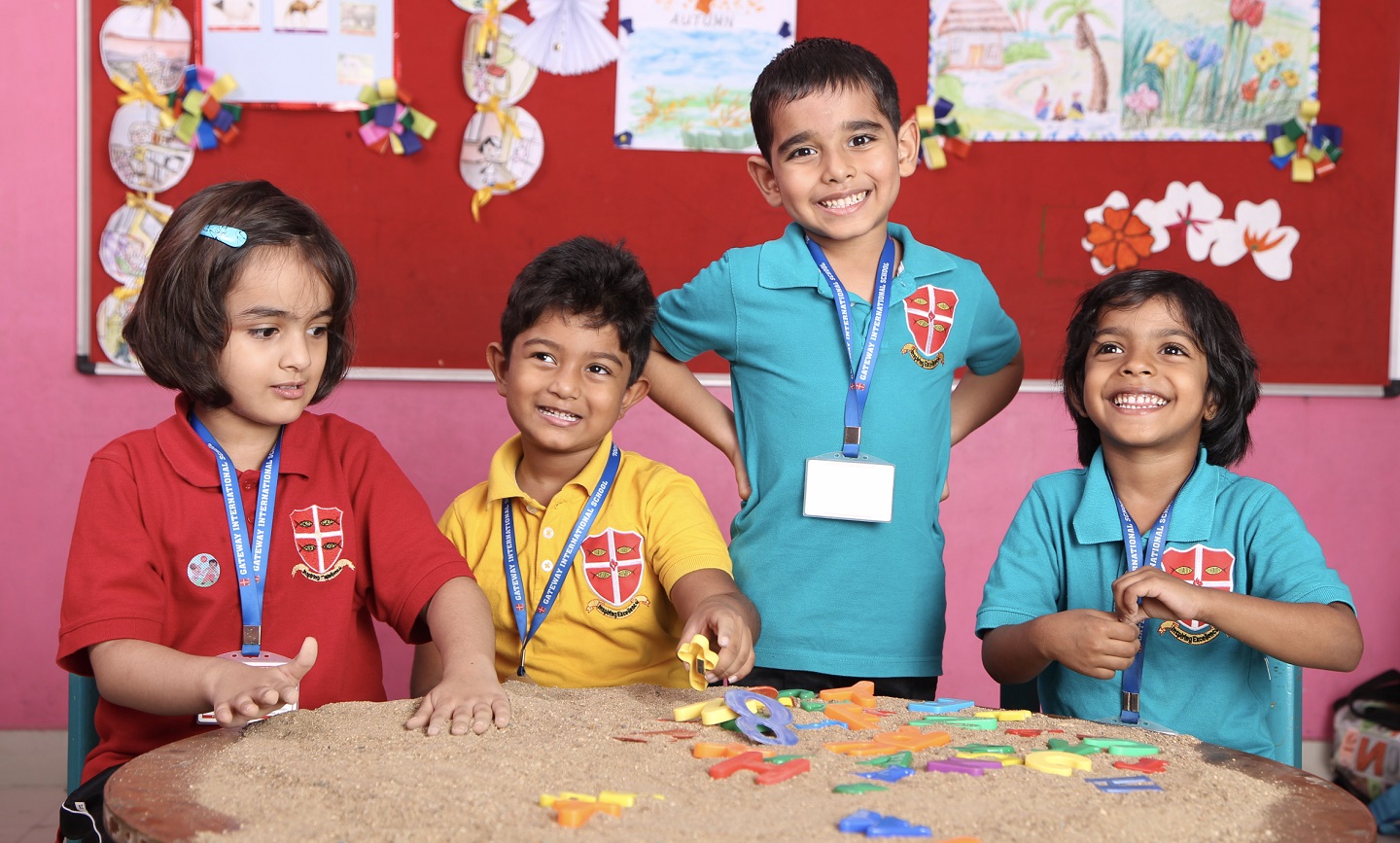 GISN-Curriculum-Sand1 KG kids involved with sand activity