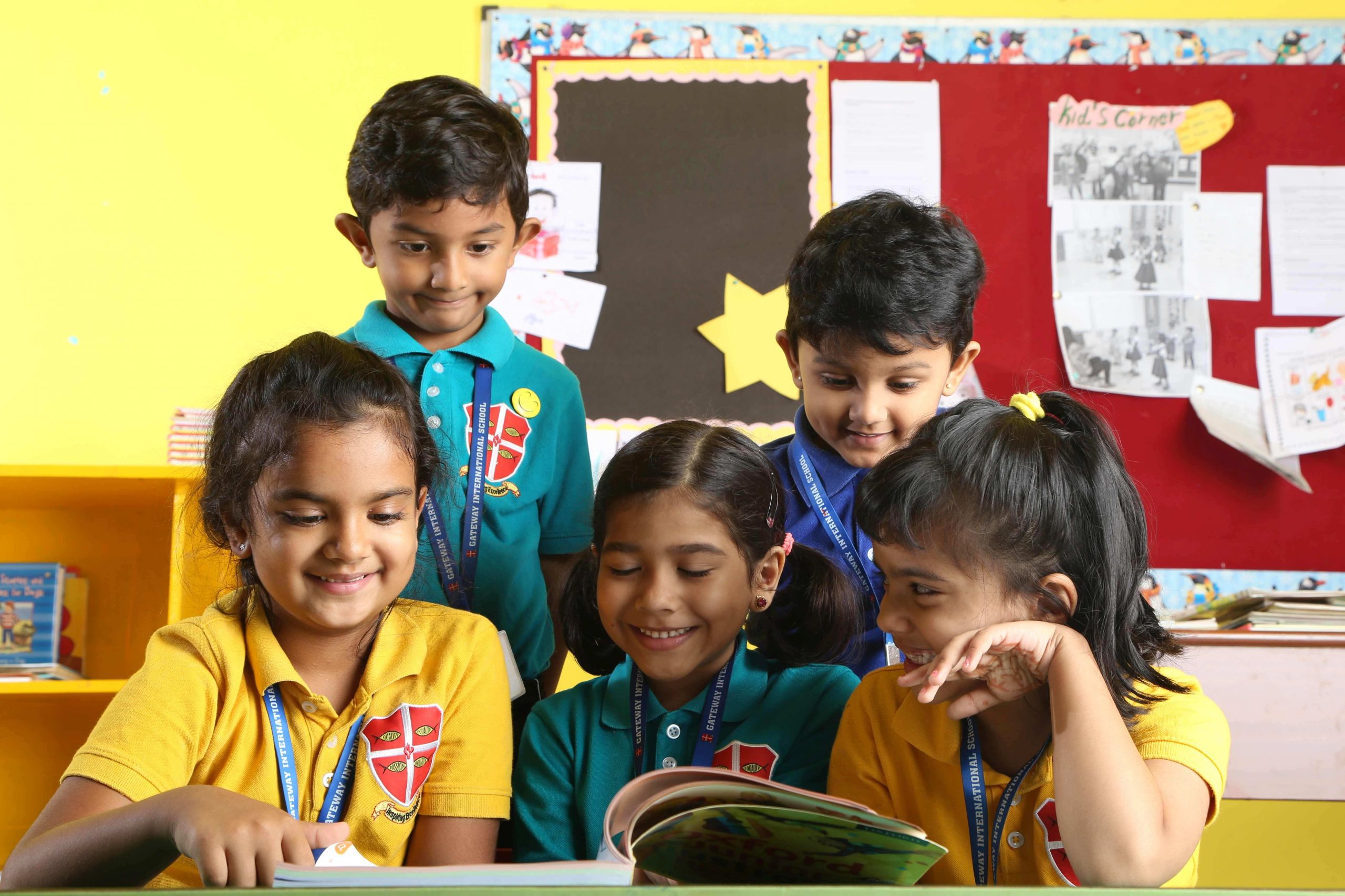 low4 KG kids involved in a reading activity
