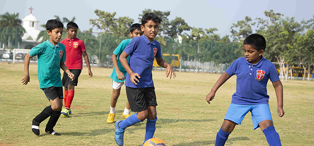 sports IB Kids Playing Football in the Ground